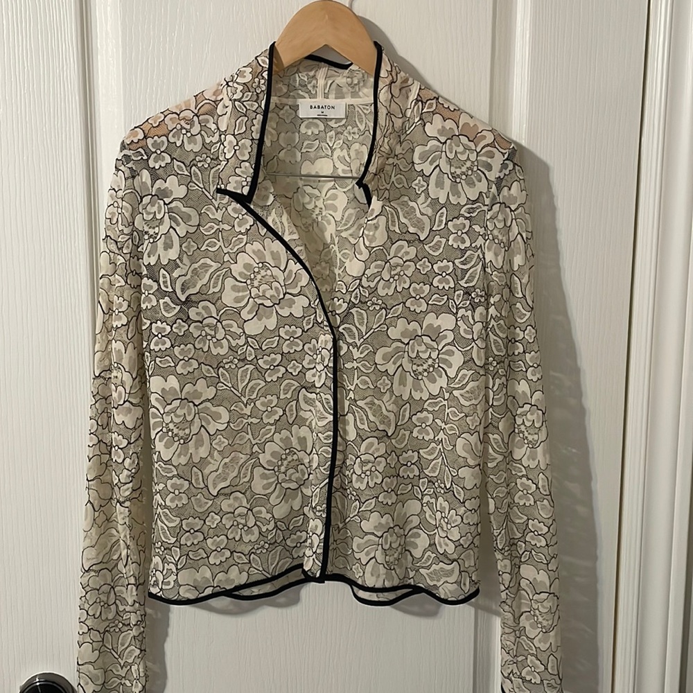 Babaton lace shirt with black trim.